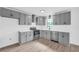 Modern kitchen featuring gray cabinets, stainless steel appliances, and hardwood floors at 2657 John Petree Rd, Powder Springs, GA 30127