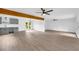 Spacious living room featuring grey vinyl floors, ceiling fans, and an open floor plan at 2657 John Petree Rd, Powder Springs, GA 30127