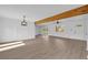 Spacious living room featuring an exposed wood beam, hardwood floors, and bright white walls at 2657 John Petree Rd, Powder Springs, GA 30127