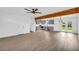 Open-concept living space with grey cabinets, modern appliances, and vinyl flooring at 2657 John Petree Rd, Powder Springs, GA 30127