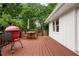 Wide wooden deck features a grill, an outdoor dining set, and ample space for entertaining at 3349 Concord Se Cir, Smyrna, GA 30080