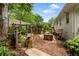 Rustic backyard with a custom pergola, charming well, and mature trees creating a tranquil, private outdoor space at 3349 Concord Se Cir, Smyrna, GA 30080