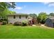 Backyard featuring a lush lawn, wooden deck with stairs, and a storage shed, offering outdoor living and storage at 3349 Concord Se Cir, Smyrna, GA 30080