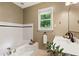 Bright bathroom with modern vanity, tiled tub, and a window with a green view at 3349 Concord Se Cir, Smyrna, GA 30080