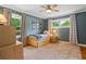 Cozy bedroom with blue walls, two windows, a ceiling fan, a bed with storage drawers, and hardwood floors at 3349 Concord Se Cir, Smyrna, GA 30080