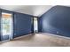 Carpeted bedroom with natural light from two windows and blue accent walls at 3385 Amhurst Pkwy, Atlanta, GA 30349