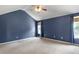 A spacious bedroom features vaulted ceilings, plush carpet, and natural light at 3385 Amhurst Pkwy, Atlanta, GA 30349