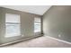 Bedroom with neutral walls and carpet, vaulted ceiling and windows bringing in natural light at 3385 Amhurst Pkwy, Atlanta, GA 30349