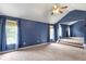 Large primary bedroom with high ceilings, plush carpeting, and lots of natural light at 3385 Amhurst Pkwy, Atlanta, GA 30349