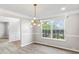 Dining area features a stylish light fixture, gray walls, and wood-look floors at 3385 Amhurst Pkwy, Atlanta, GA 30349
