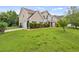 Tan two-story home with manicured lawn and mature trees in a suburban setting at 3385 Amhurst Pkwy, Atlanta, GA 30349