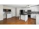 White kitchen with stainless appliances, kitchen island, and a seamless transition to the dining area at 3385 Amhurst Pkwy, Atlanta, GA 30349