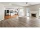 Bright living room with hardwood flooring, fireplace, and easy access to the kitchen and dining area at 3385 Amhurst Pkwy, Atlanta, GA 30349