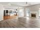 Open floor plan features a fireplace and updated flooring, connecting seamlessly to the kitchen at 3385 Amhurst Pkwy, Atlanta, GA 30349