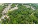 Stunning aerial view of the property surrounded by lush greenery and mature trees, highlighting its prime location at 12728 Bells Ferry Rd, Canton, GA 30114