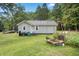 Back exterior view of a home with a well-maintained lawn and garden at 12728 Bells Ferry Rd, Canton, GA 30114