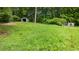 Spacious backyard featuring a storage shed, a small garden, and plenty of open green space at 12728 Bells Ferry Rd, Canton, GA 30114