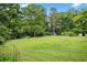 Expansive backyard featuring a well-maintained lawn, shed, and ample space for outdoor activities at 12728 Bells Ferry Rd, Canton, GA 30114