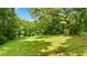 Expansive backyard featuring a well-maintained lawn, mature trees, and ample space for outdoor activities at 12728 Bells Ferry Rd, Canton, GA 30114