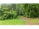Expansive backyard featuring a well-maintained lawn, mature trees, and ample space for outdoor activities at 12728 Bells Ferry Rd, Canton, GA 30114