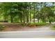 Scenic view of a property entrance with lush trees lining the driveway at 12728 Bells Ferry Rd, Canton, GA 30114