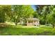 Charming home with a welcoming porch, set on a well-manicured lawn with mature trees at 12728 Bells Ferry Rd, Canton, GA 30114