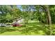A view shows a home on a well-manicured lawn with mature trees, with space for parking at 12728 Bells Ferry Rd, Canton, GA 30114