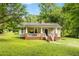 Charming home with a welcoming front porch, set on a well-manicured lawn with mature trees at 12728 Bells Ferry Rd, Canton, GA 30114