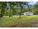 Picturesque front yard with a charming home, mature trees, and a well-maintained lawn, creating a welcoming atmosphere at 12728 Bells Ferry Rd, Canton, GA 30114