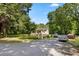 Charming home featuring a welcoming front porch and a spacious gravel driveway with ample parking at 12728 Bells Ferry Rd, Canton, GA 30114