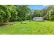 Large grassy yard featuring trees, ready for gardening or other outdoor activities at 12728 Bells Ferry Rd, Canton, GA 30114
