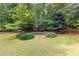 Lush backyard featuring mature trees, pond and a place to relax at 220 Broadmoor Dr, Fayetteville, GA 30215