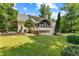 Expansive backyard with a patio, lawn, and mature landscaping at 220 Broadmoor Dr, Fayetteville, GA 30215