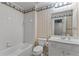 Well-lit bathroom featuring a tub, toilet, and vanity with a mirror at 220 Broadmoor Dr, Fayetteville, GA 30215