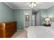 Charming bedroom with a dresser, calming paint, and an en-suite bathroom; a tranquil space at 220 Broadmoor Dr, Fayetteville, GA 30215