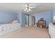 Bright blue bedroom with a trundle bed, dresser, and a toy dollhouse at 220 Broadmoor Dr, Fayetteville, GA 30215