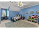 Blue bedroom with a twin bed, blue carpet, and toys on a shelf at 220 Broadmoor Dr, Fayetteville, GA 30215
