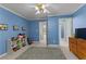 Blue bedroom with blue walls and a carpet in a well-lit home at 220 Broadmoor Dr, Fayetteville, GA 30215