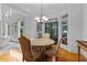 Bright breakfast nook features a round table, chandelier, hardwood floors, and plenty of natural light at 220 Broadmoor Dr, Fayetteville, GA 30215