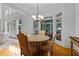 Bright dining area with wood floors and views through multiple windows at 220 Broadmoor Dr, Fayetteville, GA 30215