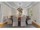 Formal dining room with tray ceiling, chandelier, large table with seating for eight, and a decorative rug at 220 Broadmoor Dr, Fayetteville, GA 30215