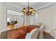 Spacious dining room with a chandelier, a large wooden table, and access to the living room at 220 Broadmoor Dr, Fayetteville, GA 30215