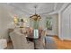 Elegant dining room with a coffered ceiling, chandelier, and a large table with seating for eight at 220 Broadmoor Dr, Fayetteville, GA 30215