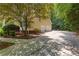 Long driveway leading to a two-car garage with mature landscaping around the property at 220 Broadmoor Dr, Fayetteville, GA 30215