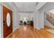 Inviting foyer featuring a wooden front door, hardwood floors, and access to the living room and stairs at 220 Broadmoor Dr, Fayetteville, GA 30215
