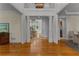 Elegant foyer with hardwood floors, white pillars, and a view of the staircase and living room at 220 Broadmoor Dr, Fayetteville, GA 30215
