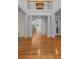 Open-concept foyer with gleaming hardwood floors and a view of the staircase and living room at 220 Broadmoor Dr, Fayetteville, GA 30215