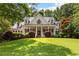 Beautiful two-story home featuring a large front yard, covered porch, and manicured landscaping at 220 Broadmoor Dr, Fayetteville, GA 30215