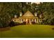 Traditional home with manicured lawn, mature trees, and inviting covered front porch at 220 Broadmoor Dr, Fayetteville, GA 30215