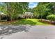 Charming two-story house with mature trees, well-maintained lawn, and inviting curb appeal at 220 Broadmoor Dr, Fayetteville, GA 30215
